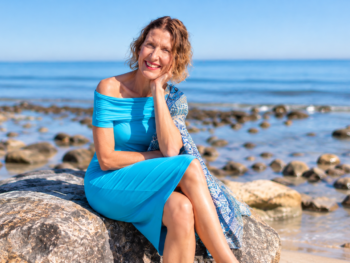 Kate Driver, The Midlife Health Detective, sitting by the beach in Adelaide